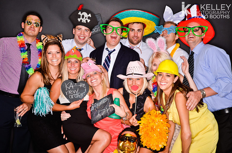 A large group of friends take their photograph in a large open air photo booth at a Columbia Mo Wedding Reception
