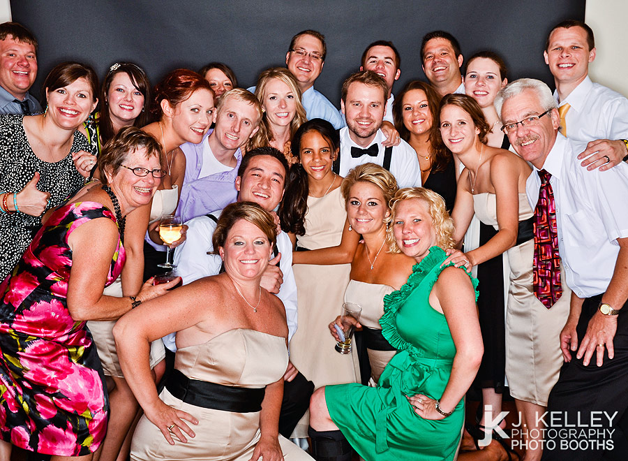 Large group takes their photo with the birde and groom in an open air photo booth in Columbia Missouri