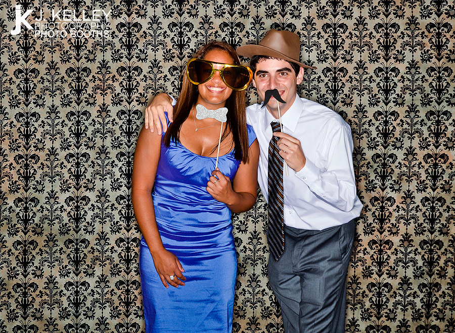 A photo booth is used by guests at a wedding reception in Columbia MO